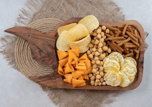 Variety of delicious snacks on wooden board. High quality photo